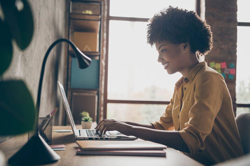 female professional working on laptop in home office